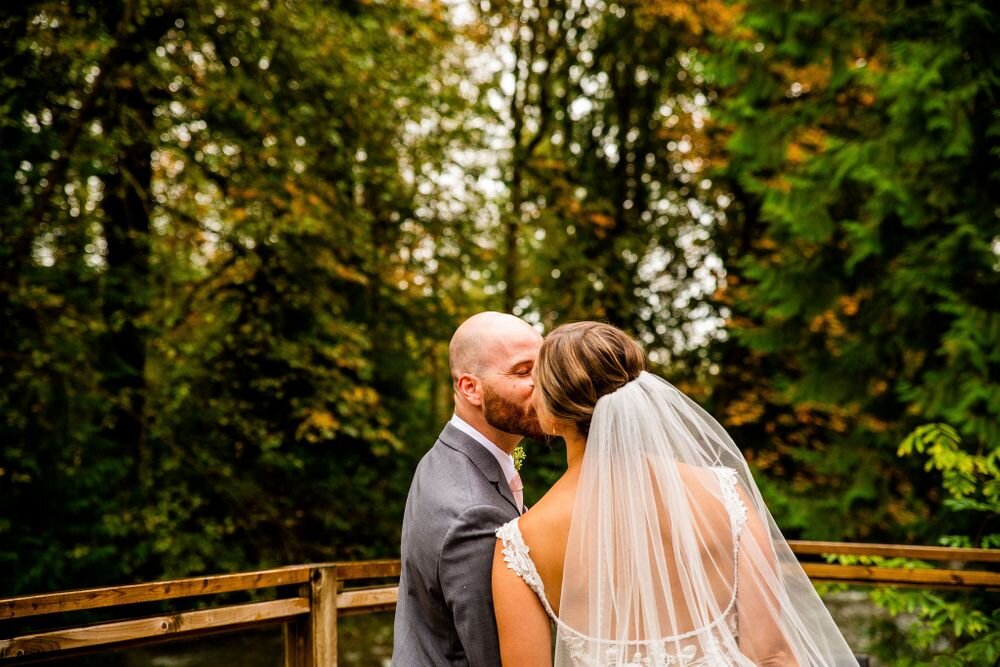 Newlyweds kissing during bridal portrait in golden ears provincial park BC
