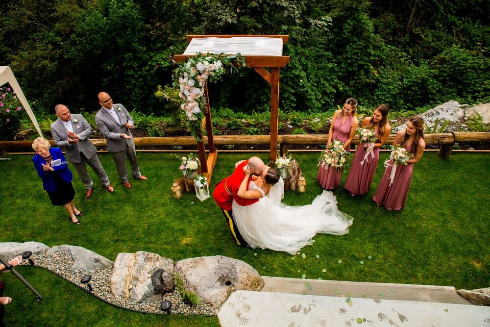 Kissing at the end of an intimate backyard wedding in Maple Ridge BC
