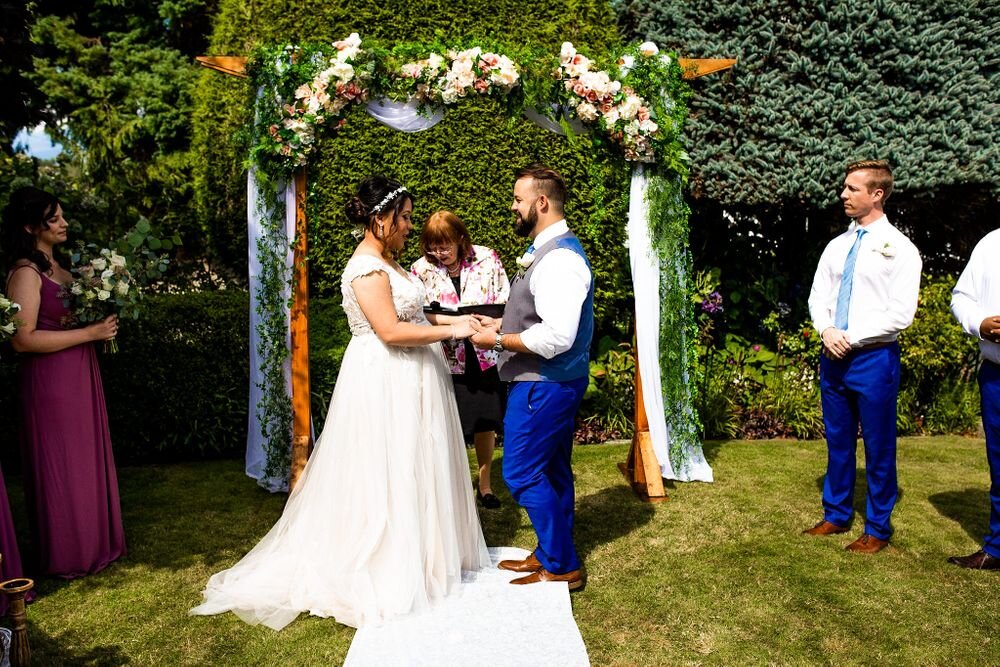 Bride and groom saying their vows at their backyard wedding ceremony in BC