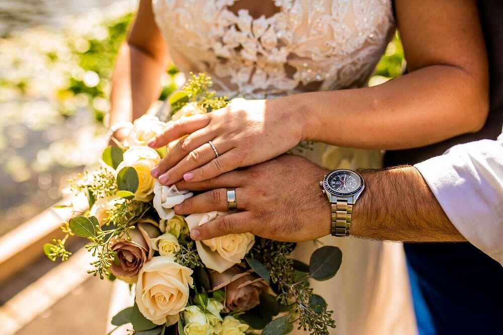 Close up of bride and groom's rings at their backyard wedding ceremony in BC