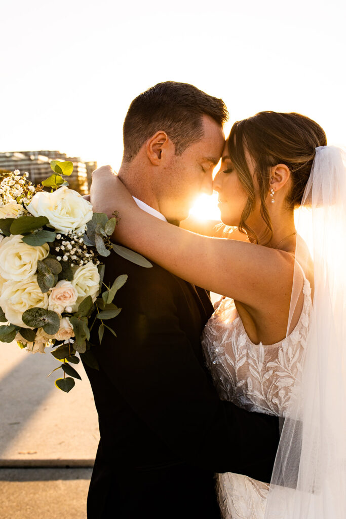 Sunset photo of bride and groom embracing