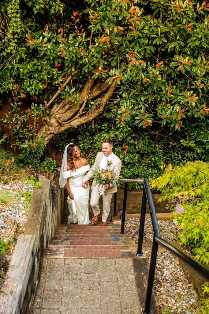 Backyard wedding with couple walking up stairs