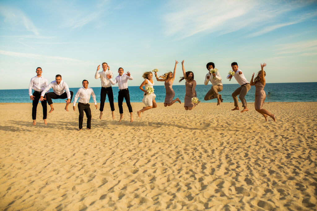 Group jumping in the air on the beach at a Cabo San Lucas wedding
