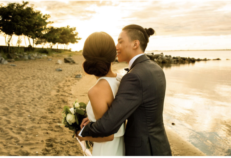 Classic wedding photos of newlyweds on a beach at sunset