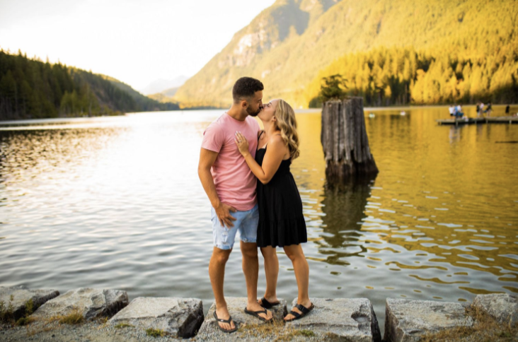 Engagement shoot on a lake with mountain backdrop