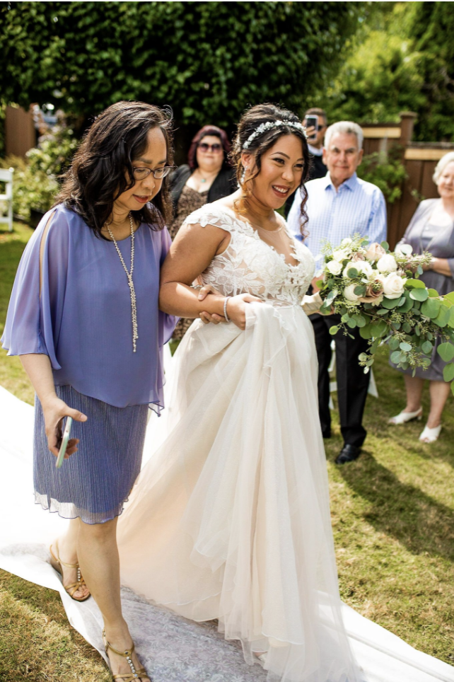 Mom walking bride down the aisle backyard wedding ceremony in BC