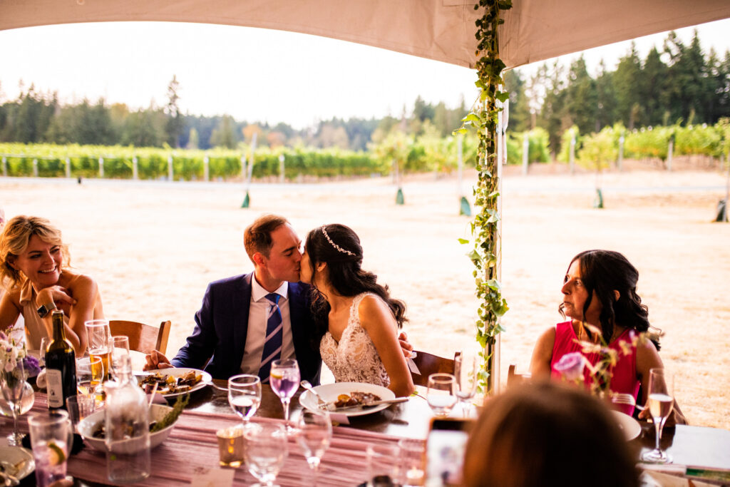 Newlyweds kissing at a winery wedding in Vancouver