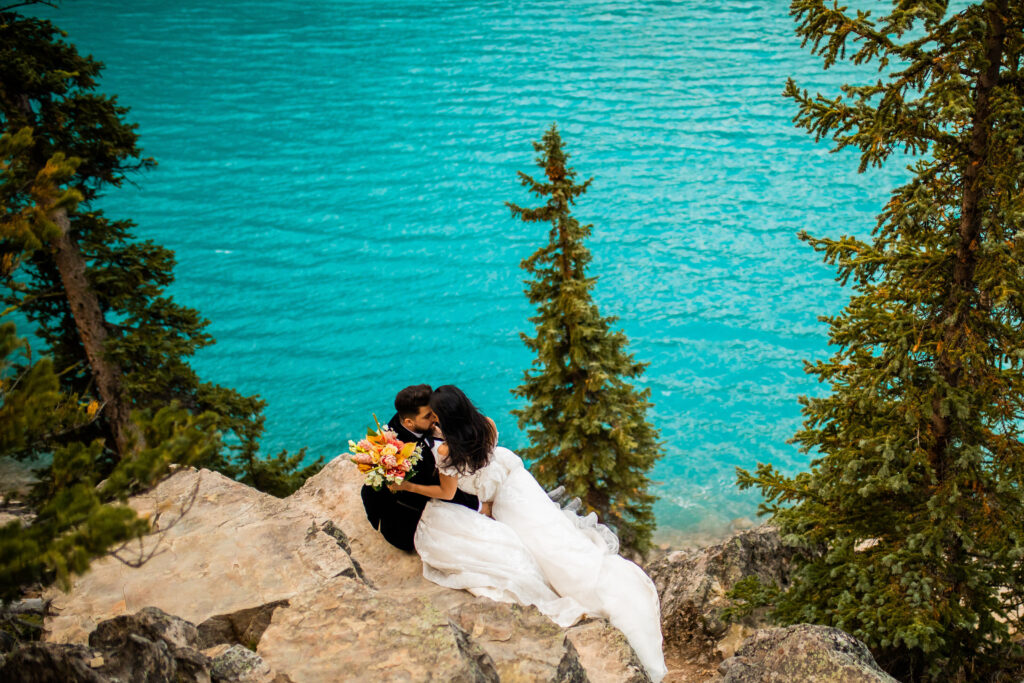 Couple kissing on a cliff during photoshoot in Alberta Canada