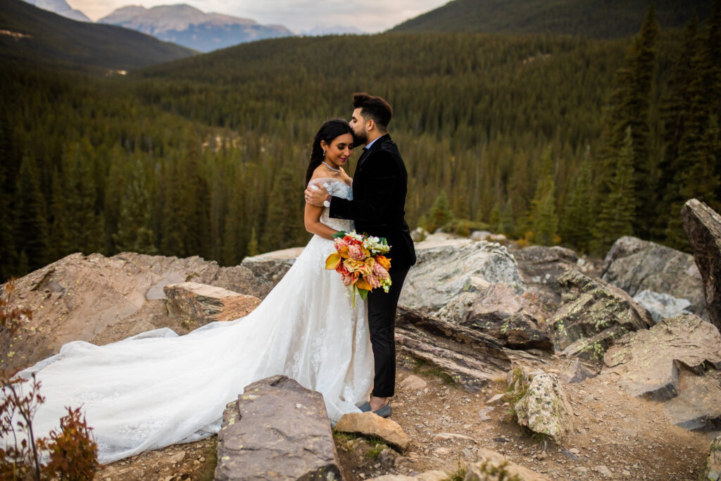 Newlyweds embracing on top of a mountain in BC