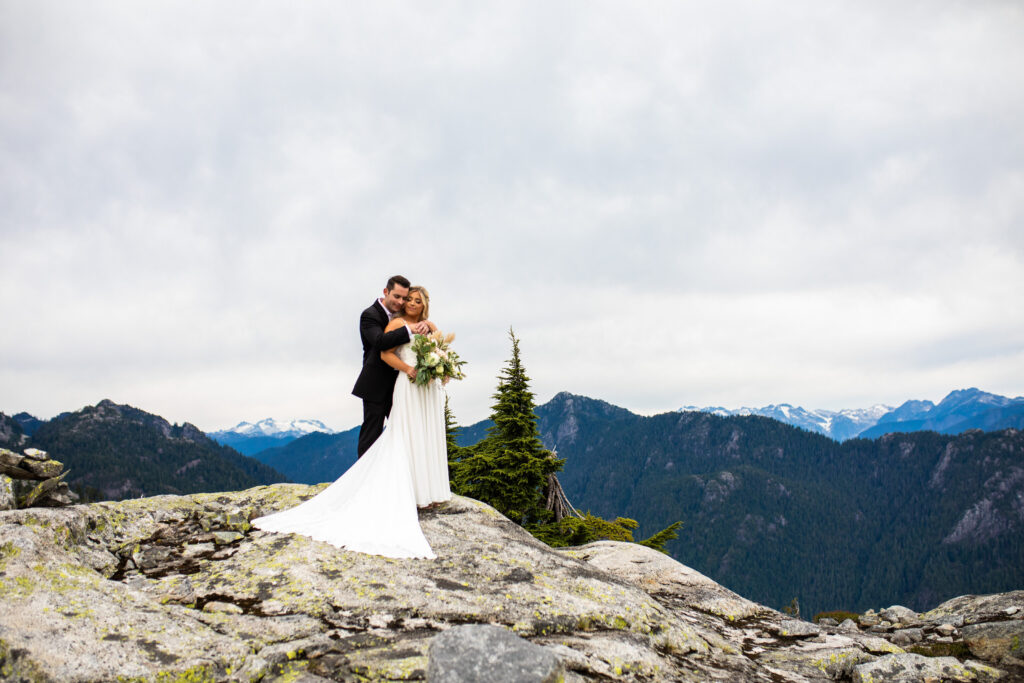 Wedding portrait on top of a mountain at their heli wedding
