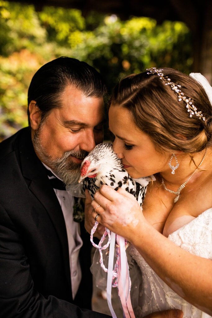 Newlyweds with their sweet pet chicken at their wedding