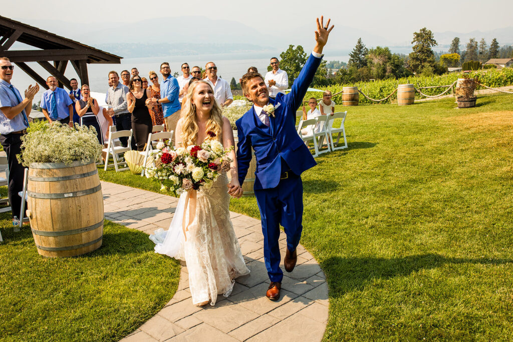 Happy couple just married walking down the aisle at their Kelowna wedding