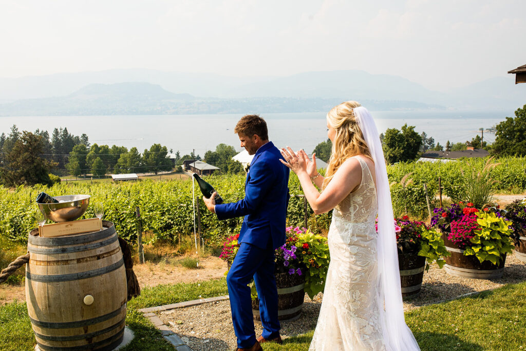 Newlyweds popping bubbly at their Kelowna wedding