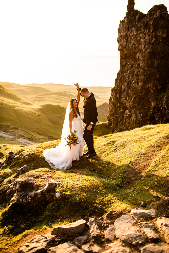 Sunset wedding photo of couple on a mountain with greenery