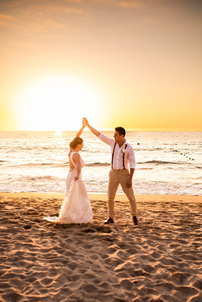 Newlyweds dancing on the beach at their Cabo San Lucas wedding