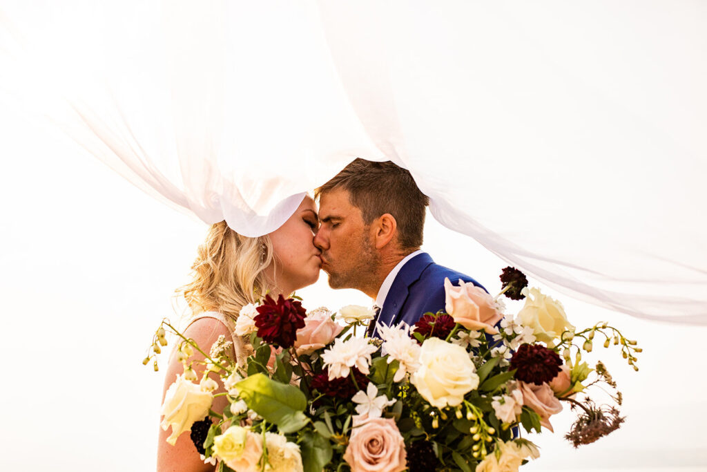 Newlyweds kissing at their wedding in Kelowna