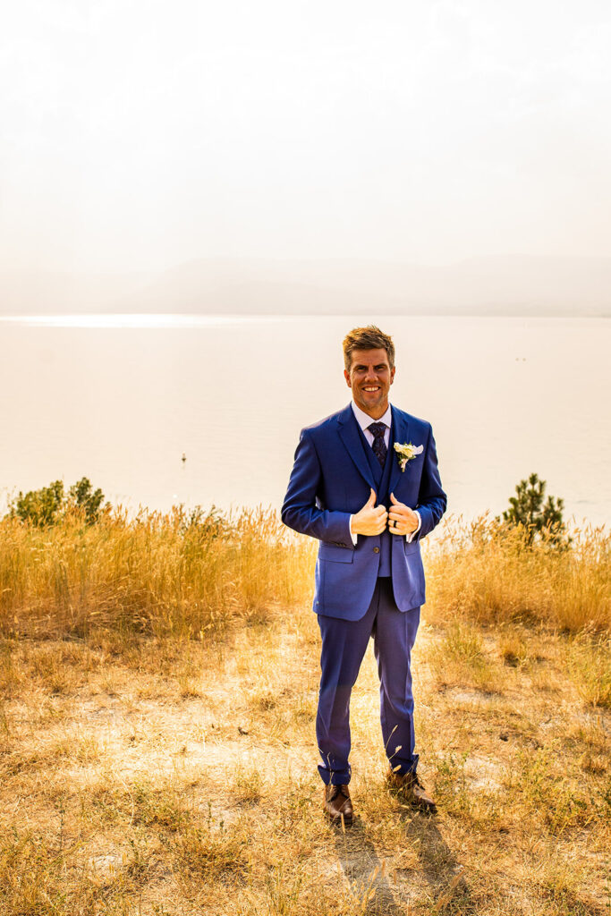 Groom posing on the waterfront at his Kelowna wedding