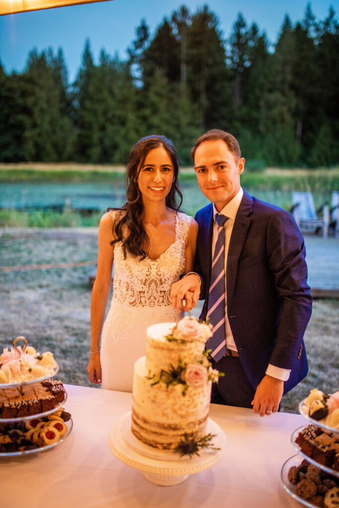 Bride and groom with cake Vancouver Island Wedding At Enrico Winery