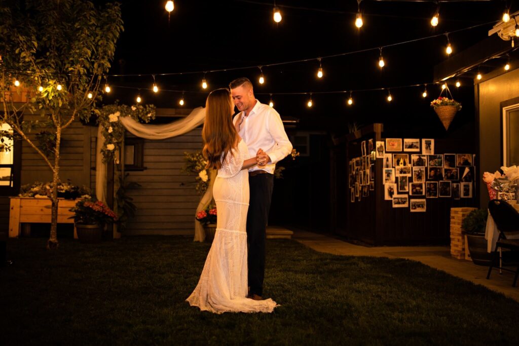 Bride and groom dancing at their backyard wedding reception

