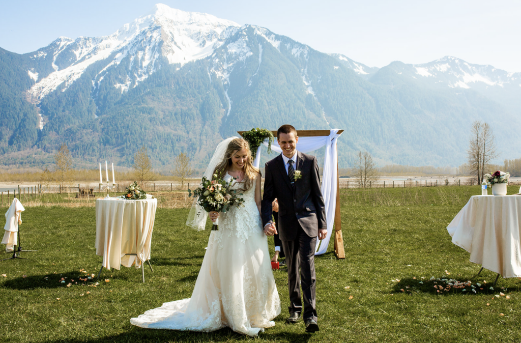 Fraser Ridge Lodge wedding ceremony with mountain backdrop